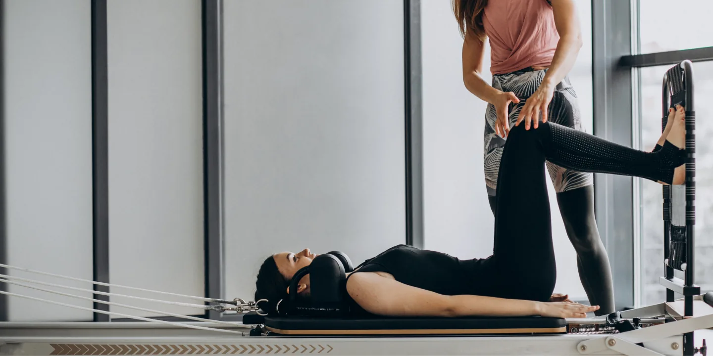 Woman training on Pilates reformer